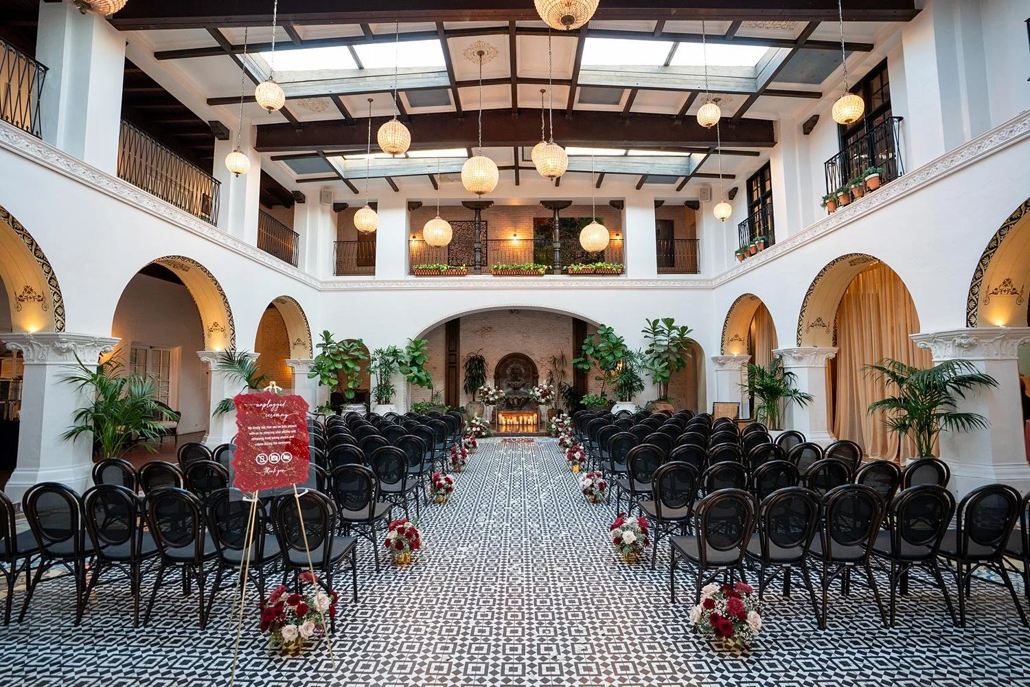 Wedding ceremony in the courtyard at the Ebell of Long Beach with guests seated