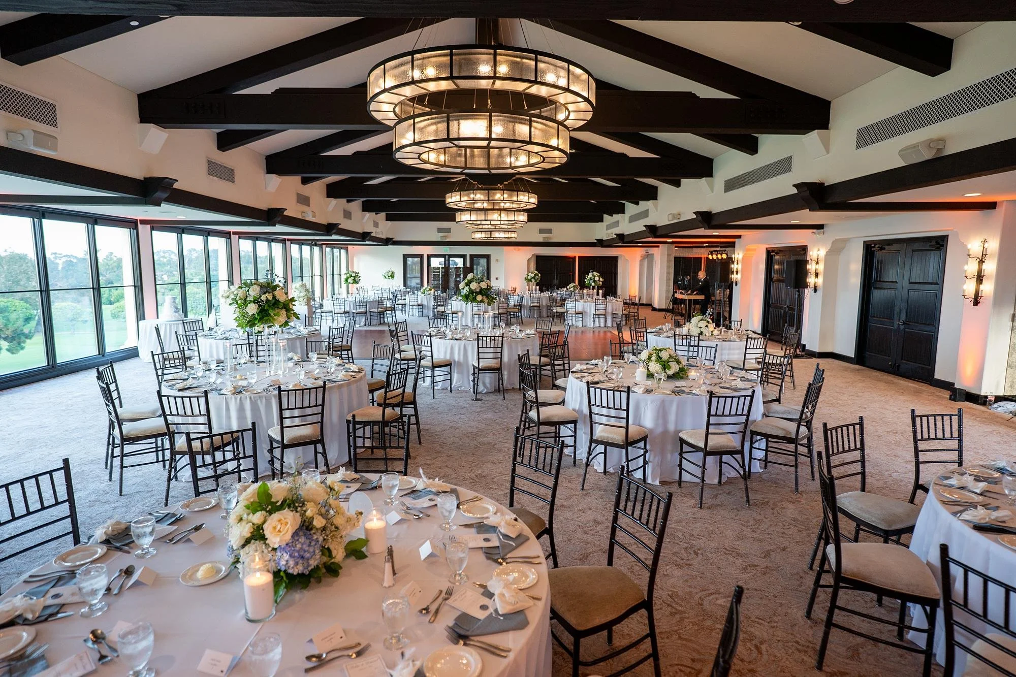 Wedding reception tables with white roses and purple hydrangeas at Palos Verdes Golf Club