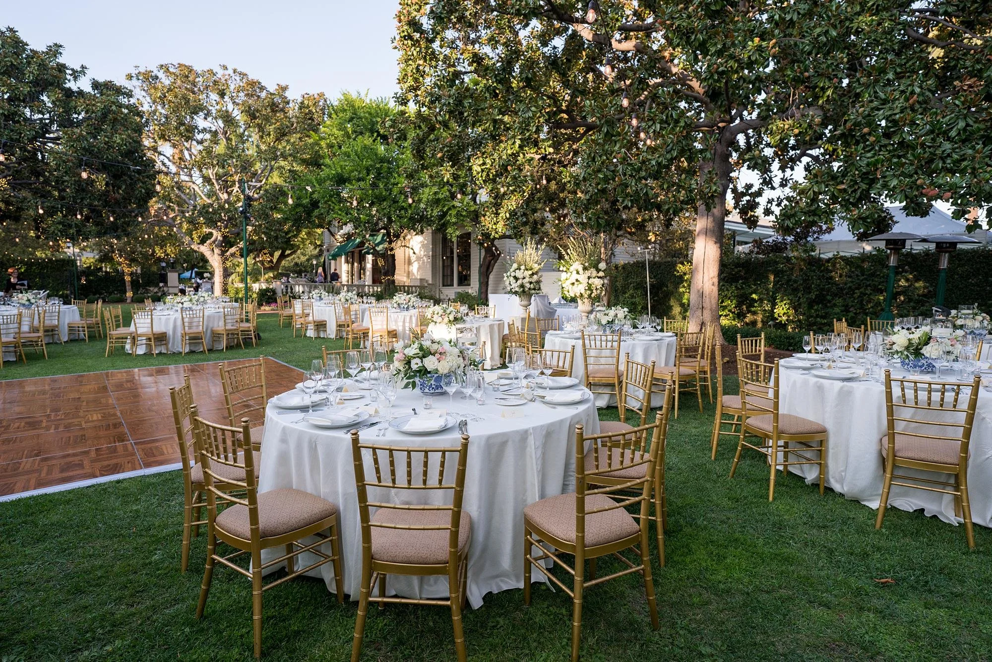 Wedding reception on the Front Lawn with dance floor and florals at the Valley Hunt Club