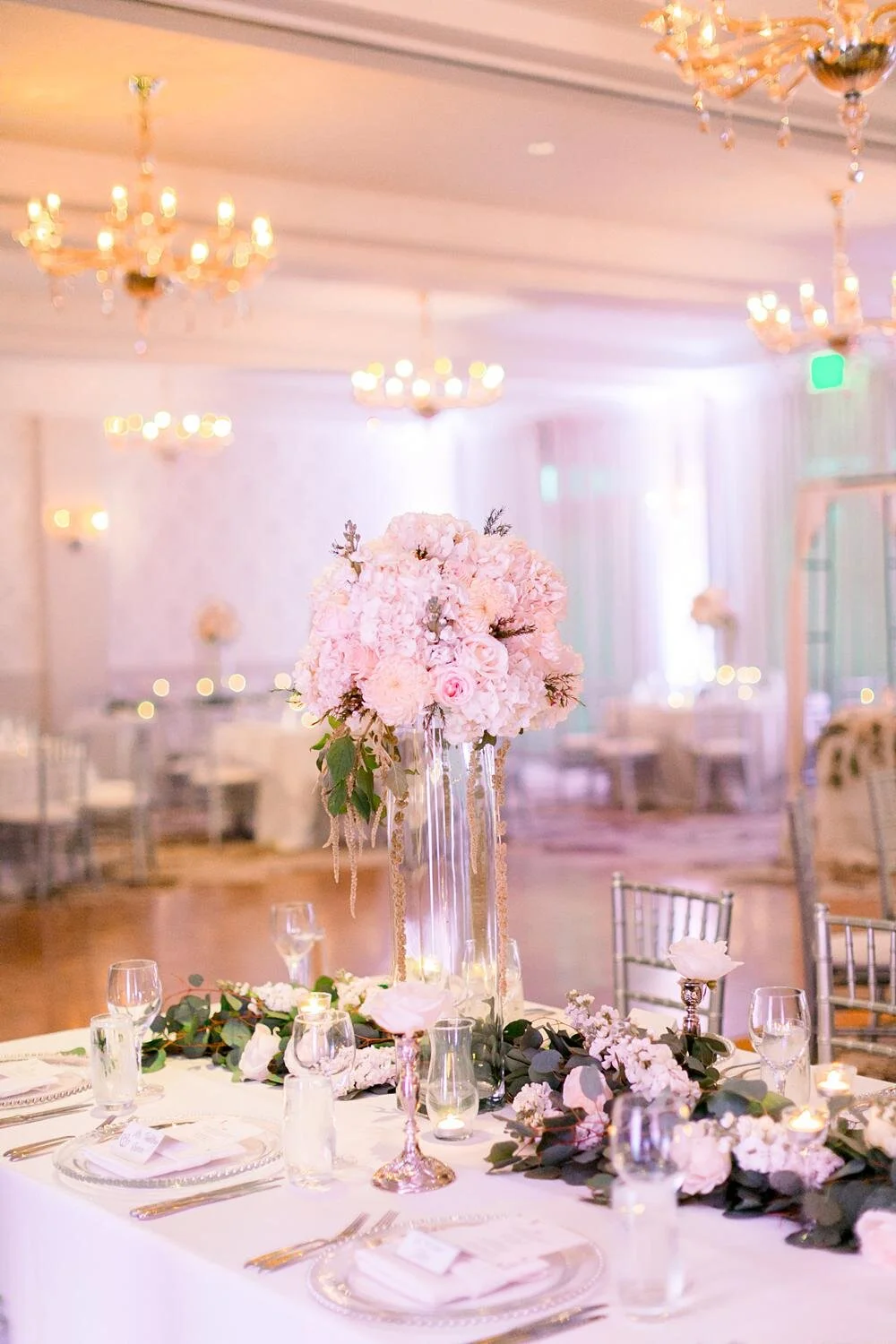 Tall floral centerpieces for a Riverside Ballroom wedding reception at Belmond El Encanto