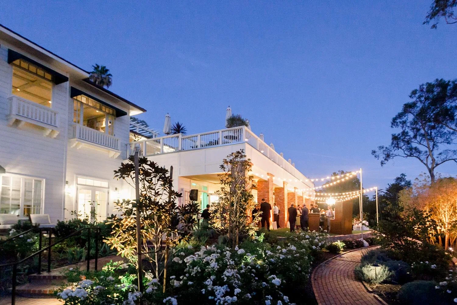 Evening wedding cocktails at the Riverside Ballroom with guests enjoying drinks at Belmond El Encanto