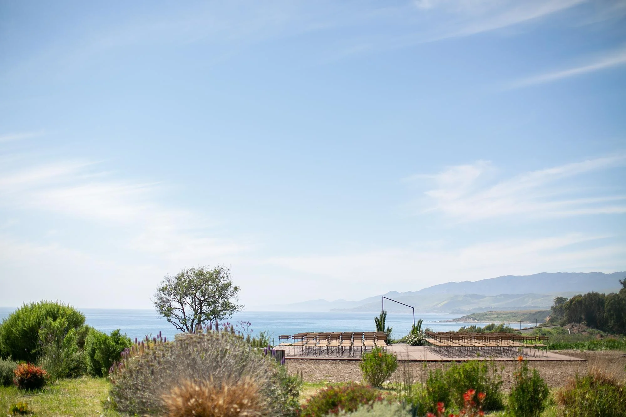 Wedding ceremony with triangular arch overlooking the coast at Dos Pueblos Orchid Farm