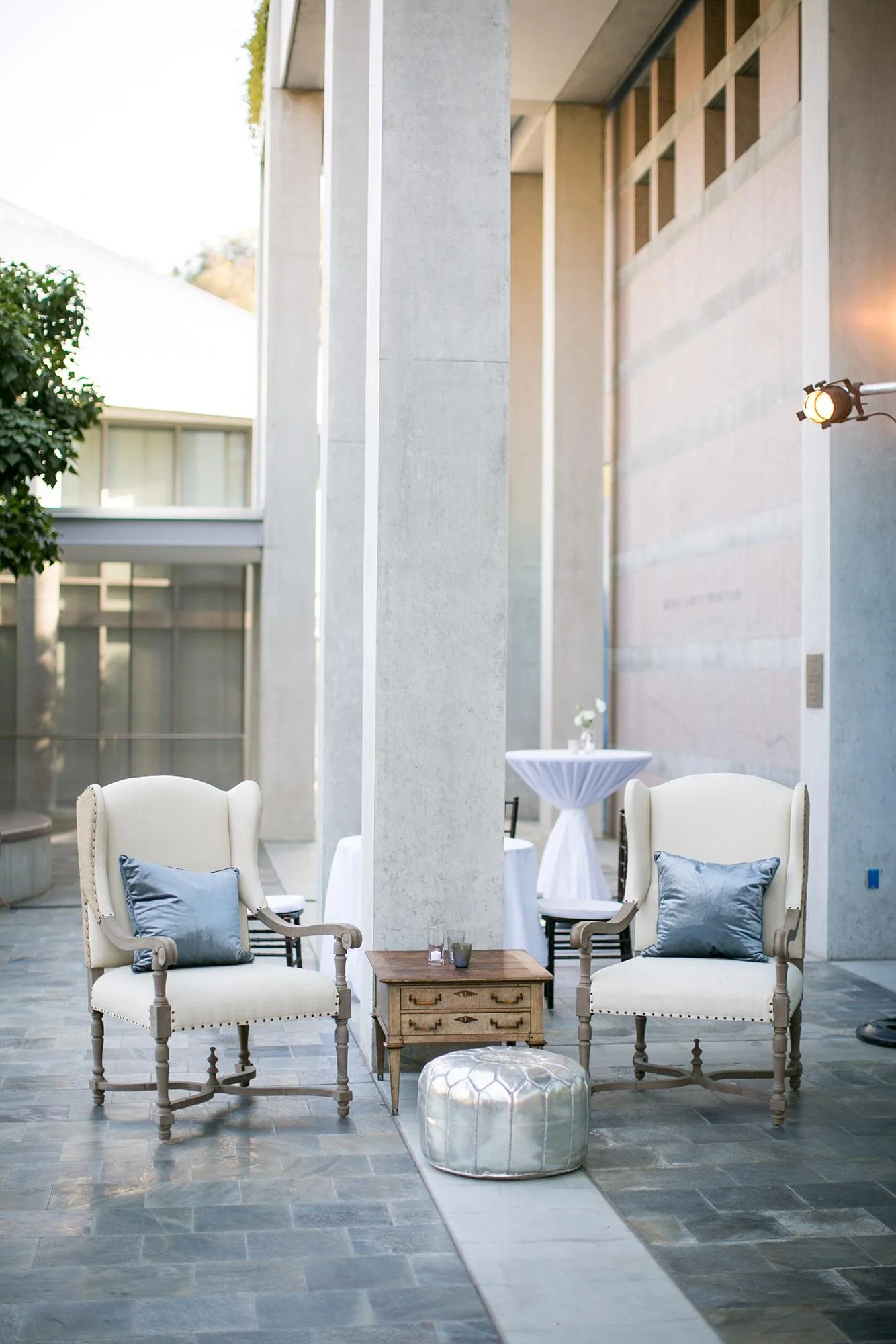 Guerin courtyard prepared for wedding cocktail hour with tables and décor at the Skirball Cultural Center