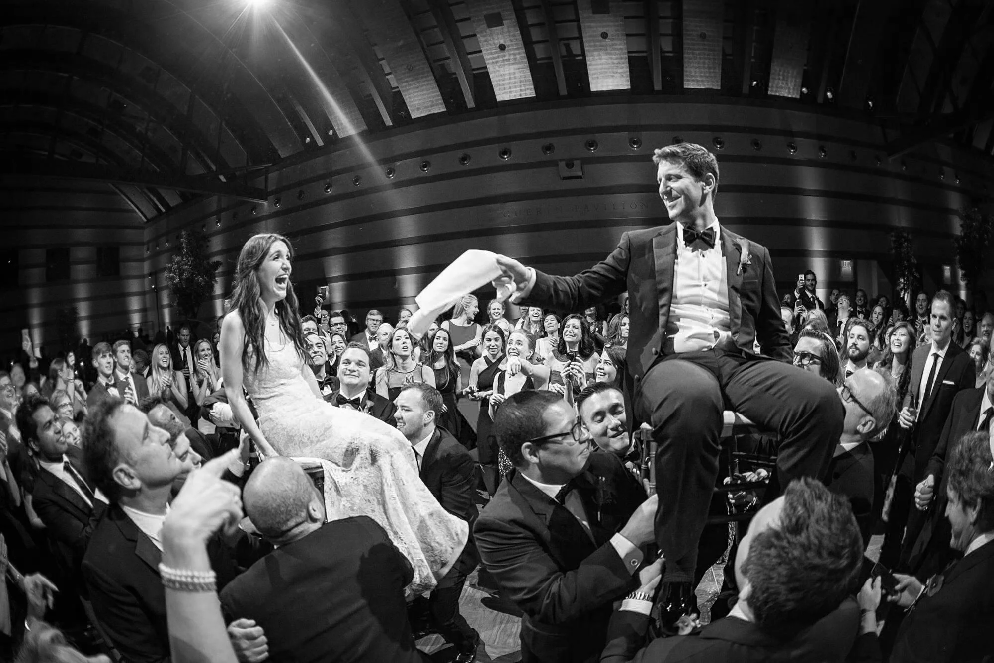 Bride and groom celebrating the hora during the Guerin Ballroom wedding reception at Skirball Cultural Center