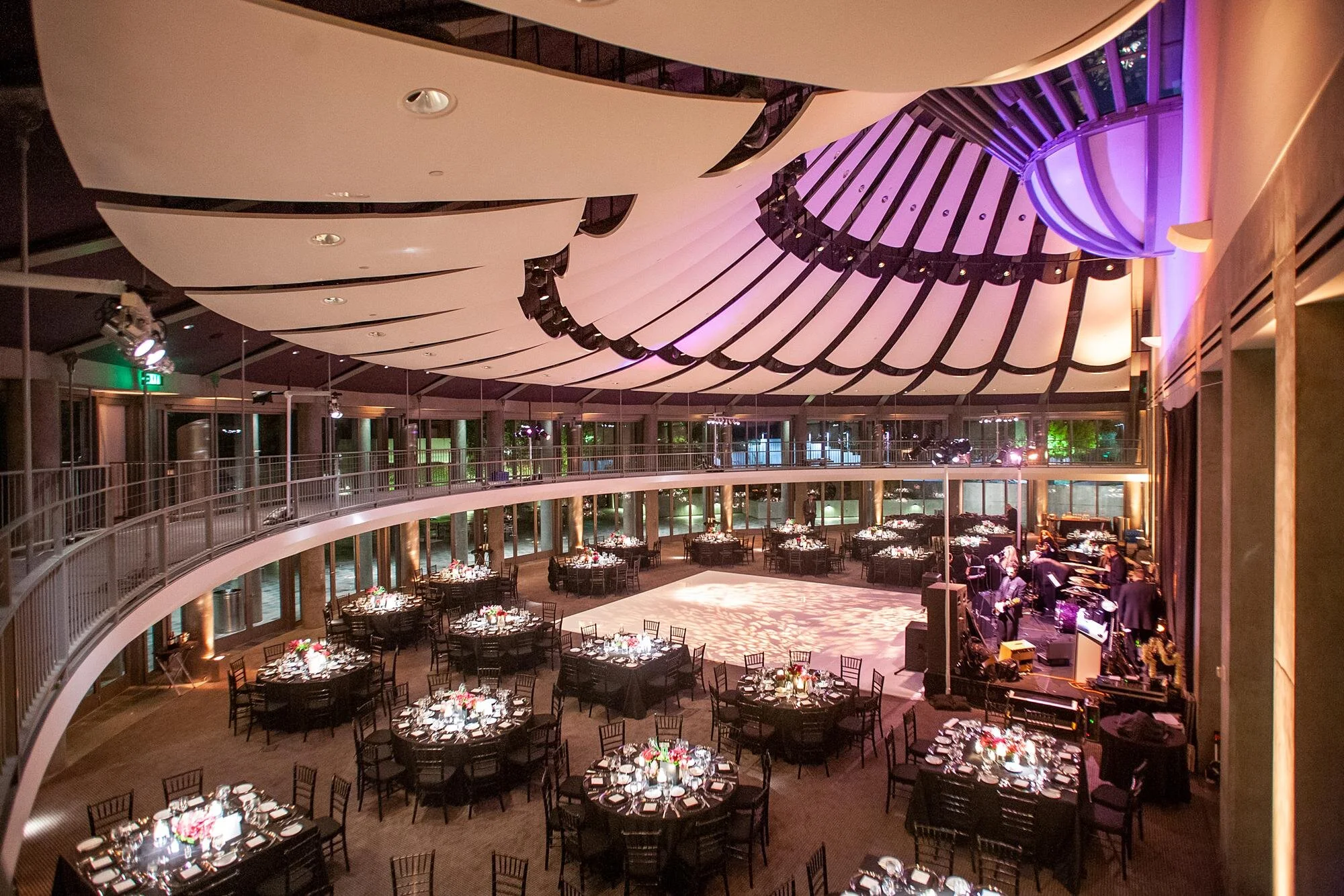 Floral arrangements and table settings during a wedding reception in the Ahmanson Ballroom at the Skirball Cultural Center