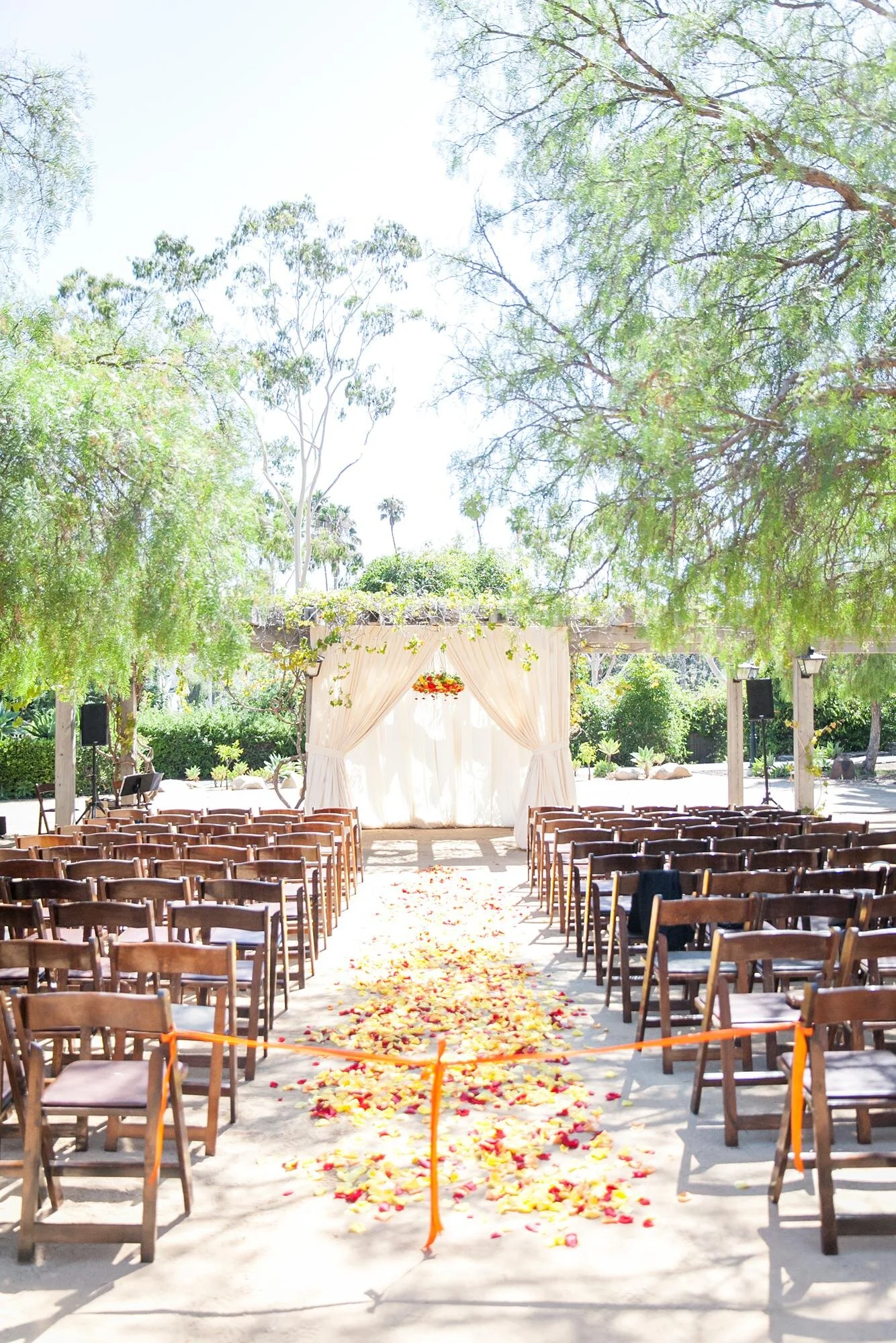 Wedding ceremony arch with floral chandelier and drapery in the Santa Barbara Historical Museum Adobe Courtyard