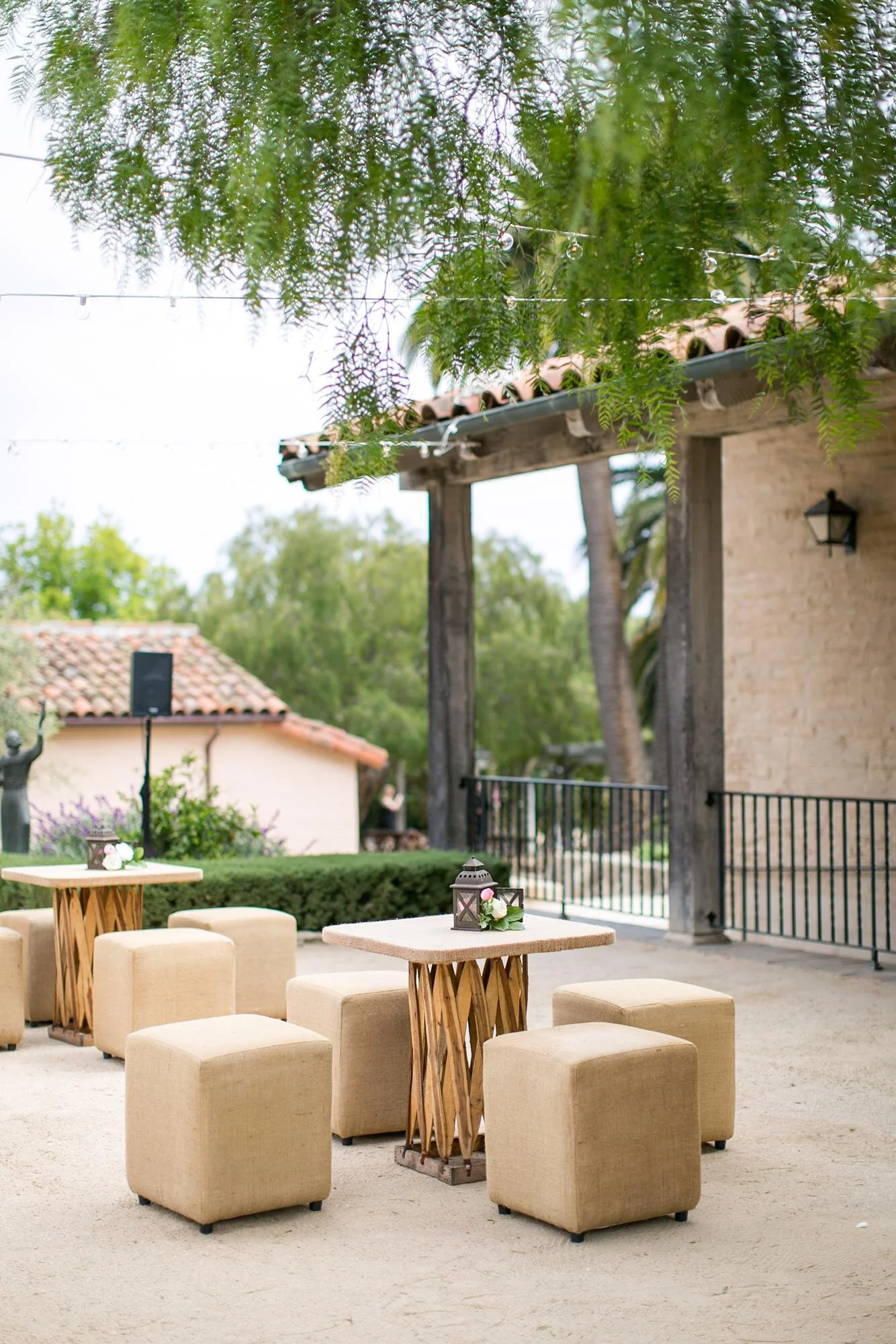Wedding cocktails with wooden tables arranged in the Courtyard at Santa Barbara Historical Museum