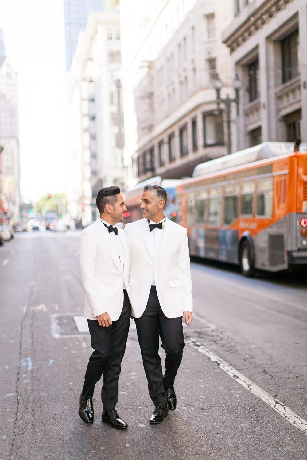 Wedding portrait of grooms walking together on a downtown street near the Alexandria Ballrooms