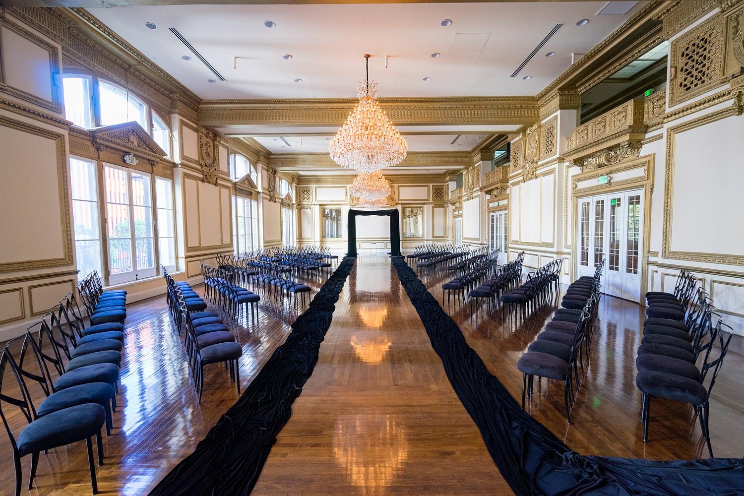 Wedding ceremony in the King Edward Ballroom with a black fabric lined aisle at the Alexandria Ballrooms