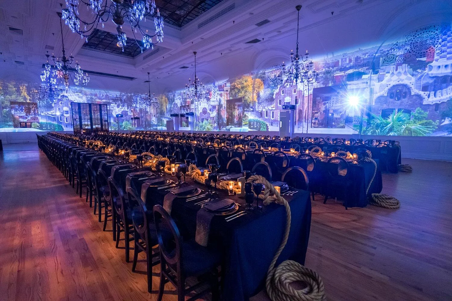 Wedding reception with wall projections and decorated tables in Palm Court Ballroom at the Alexandria Ballrooms