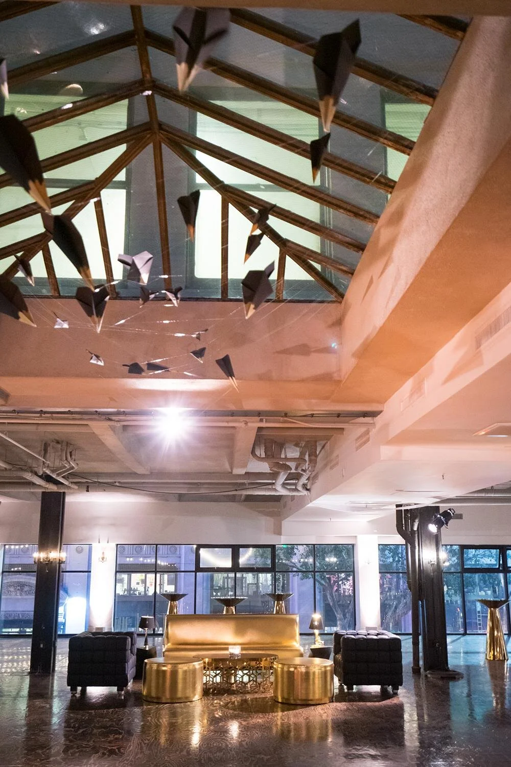 Wedding reception seating area beneath skylights and large windows at the Alexandria Ballrooms