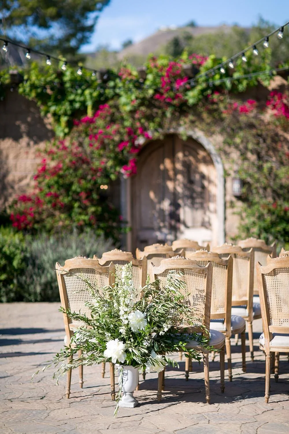 Wedding ceremony floral detail beside guest chairs at Catalina View Gardens