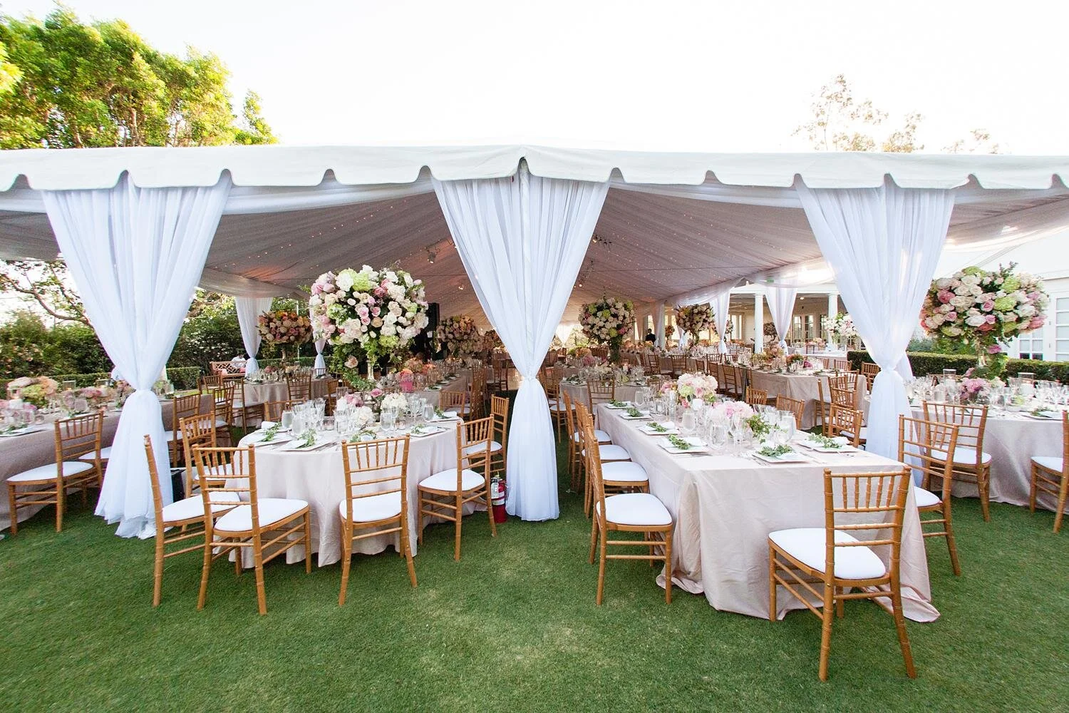 Wedding reception setup on the lawn at Annandale Golf Club with tented seating and floral décor