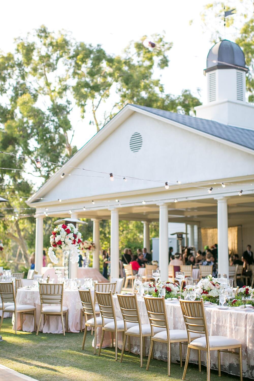 Wedding reception tables arranged outdoors at Annandale Golf Club with the clubhouse visible in the background