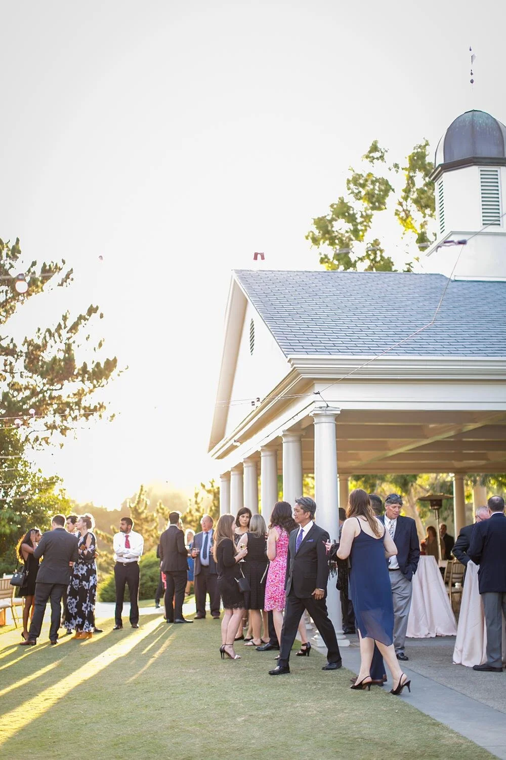 Wedding cocktails with guests mingling on the side lawn at Annandale Golf Club during cocktail hour