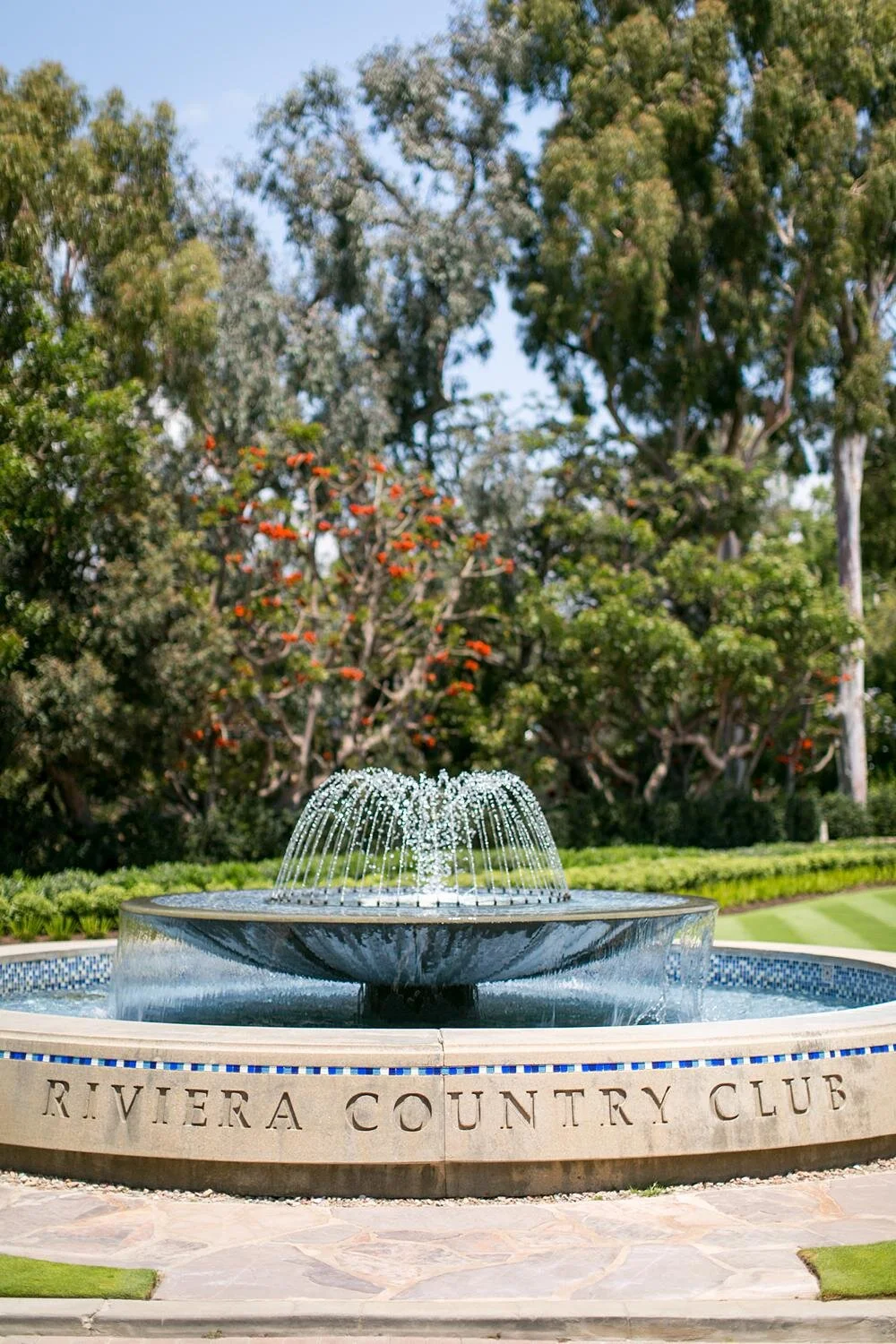 Wedding scenery at Riviera Country Club featuring the fountain in the entrance driveway