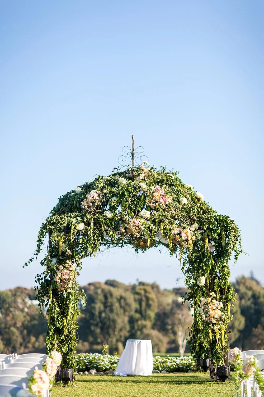 Wedding reception at Riviera Country Club in the Crystal Ballroom with tall pink florals