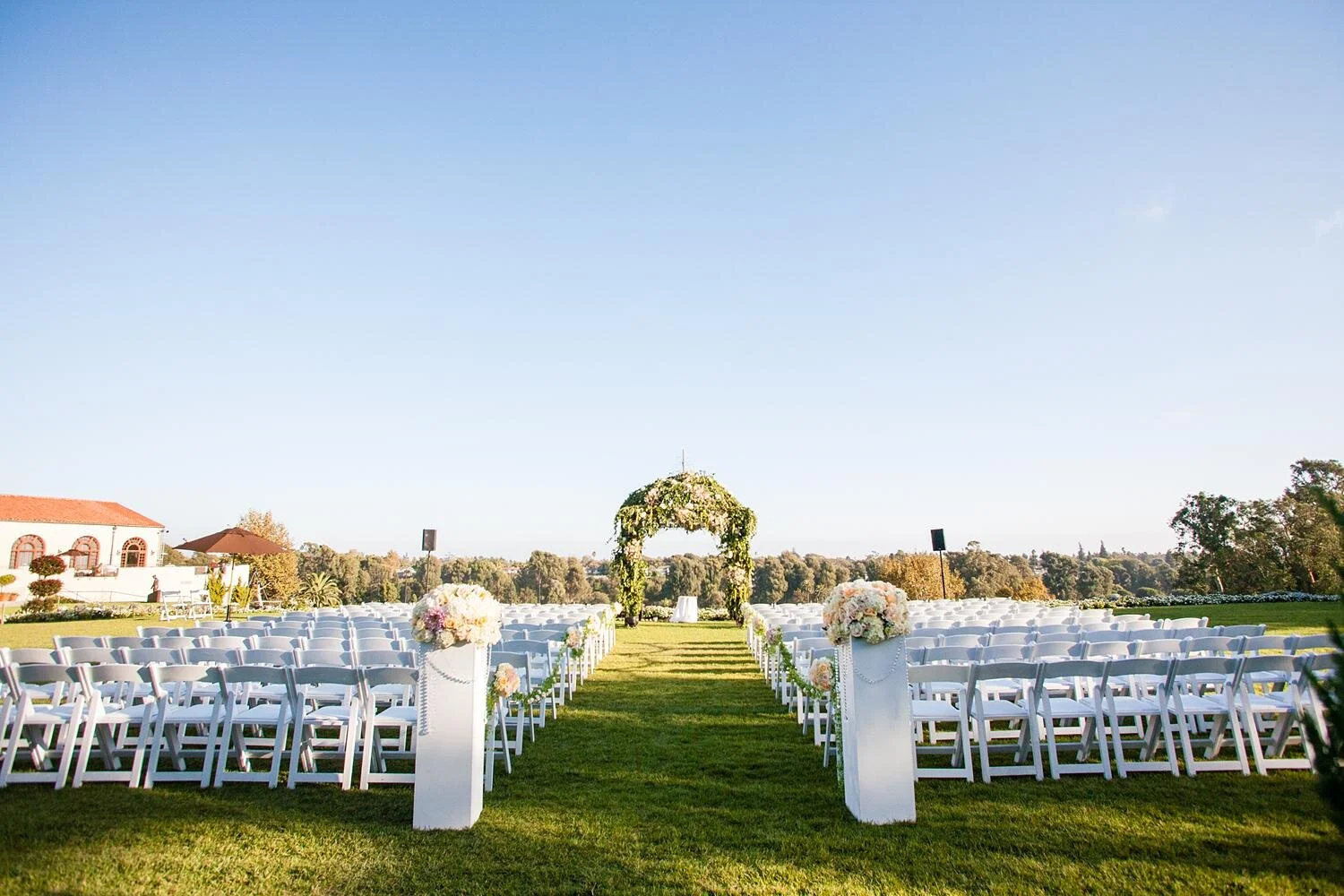 Wedding ceremony at Riviera Country Club with views across the golf course