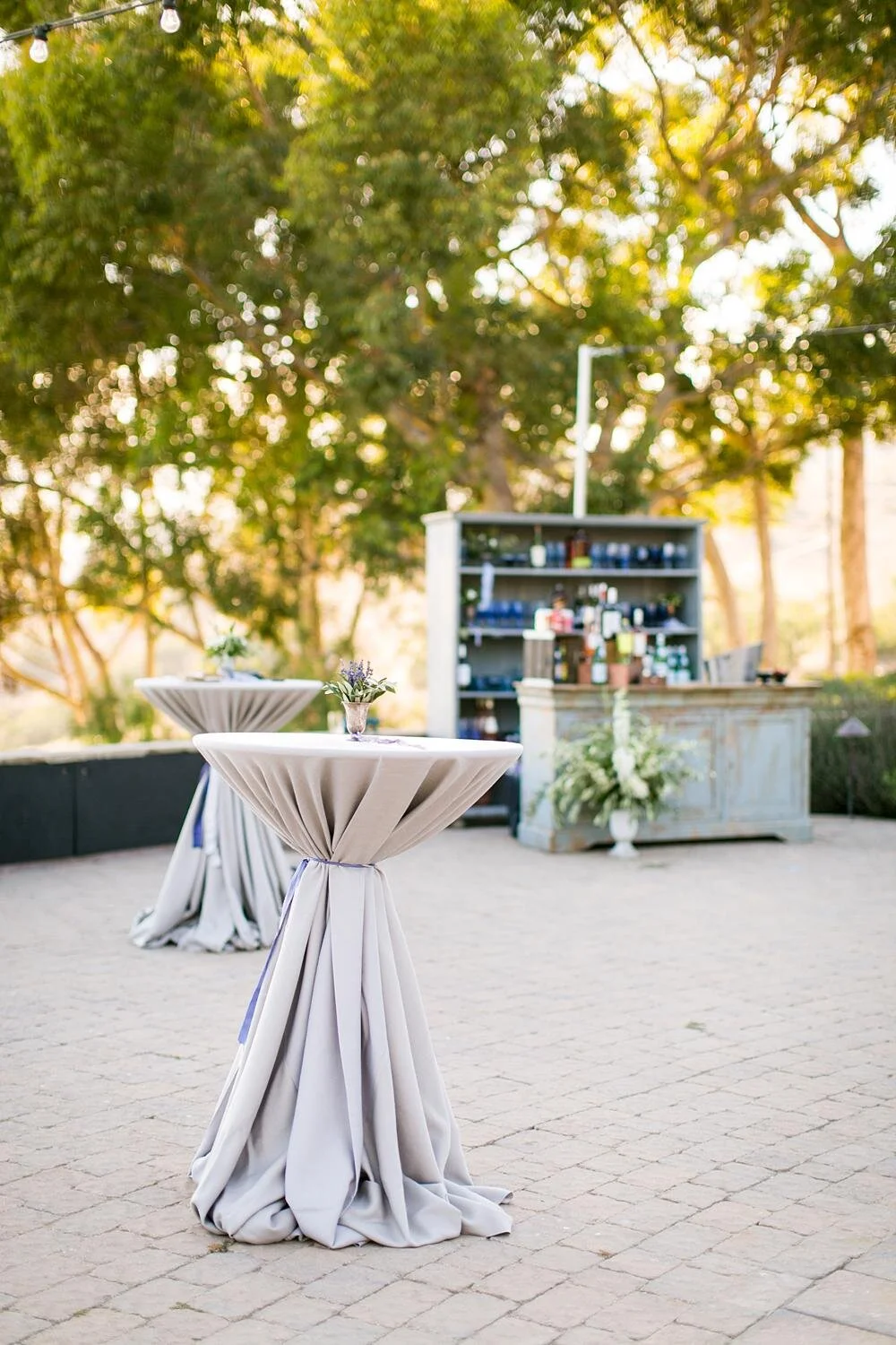 Wedding cocktail hour table detail with custom bar behind at Catalina View Gardens