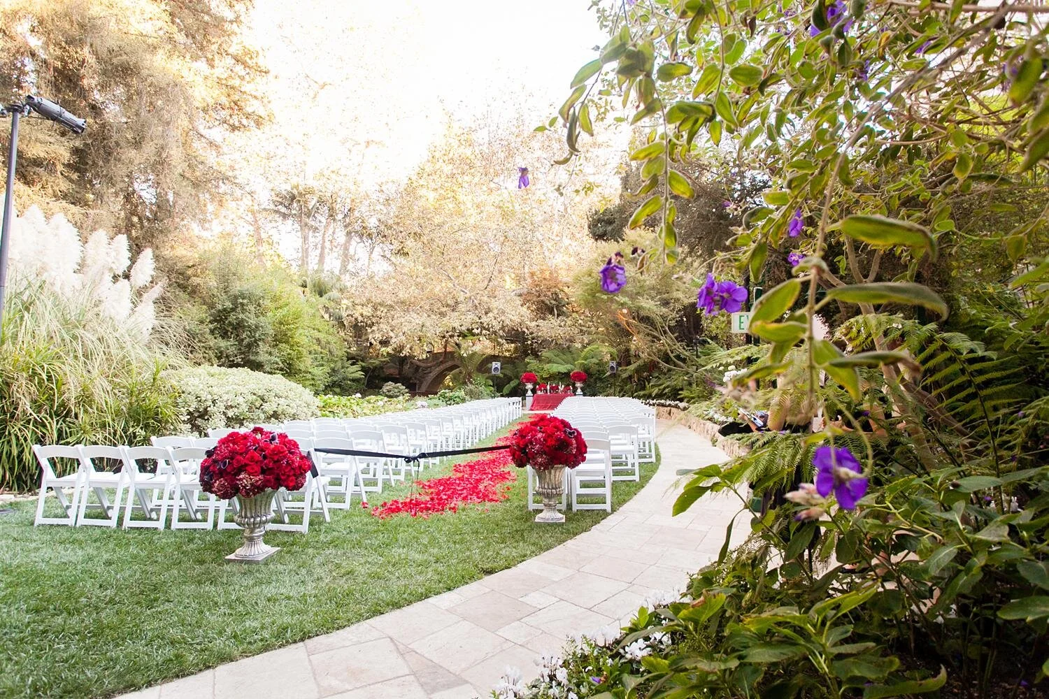 Wedding ceremony décor of red roses at a Swan Lake ceremony area at Hotel Bel Air