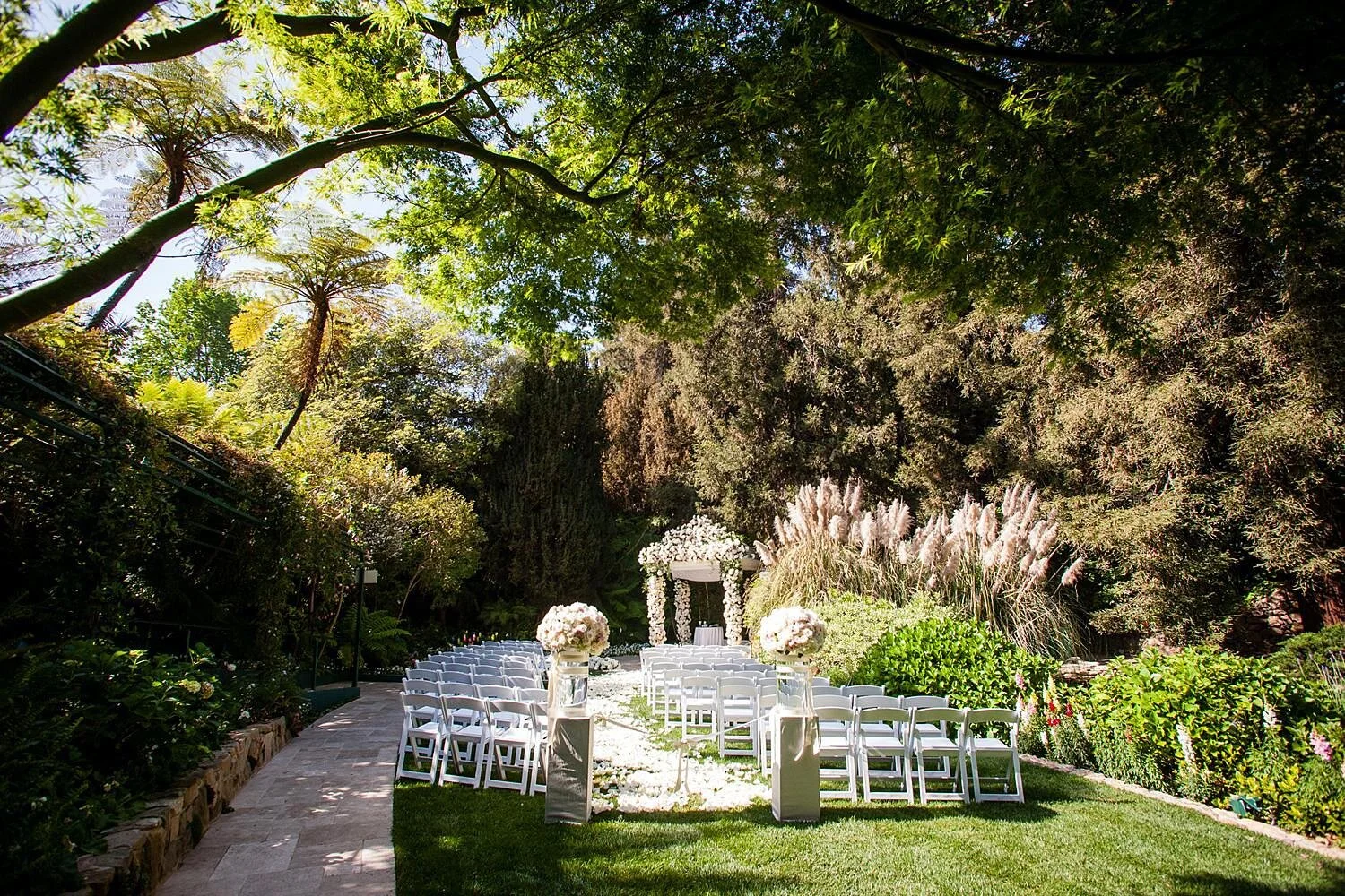 Wedding ceremony featuring a chuppah decorated with white roses at Hotel Bel Air