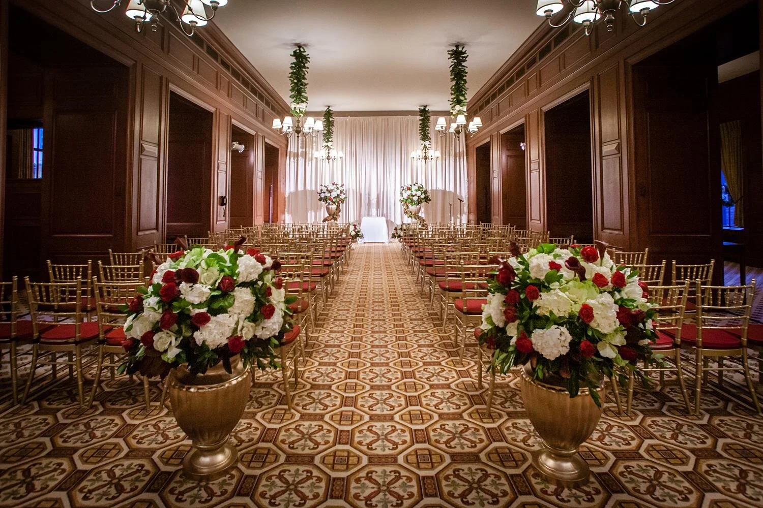 Wedding ceremony setup with gold chairs and red roses in the Third Floor Dining Room at the California Club