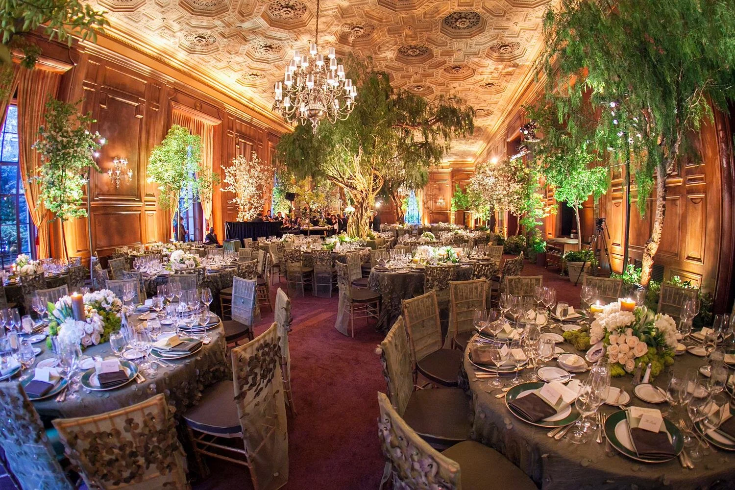 Wedding reception in the Main Dining Room at the California Club with trees and garden-inspired centerpieces