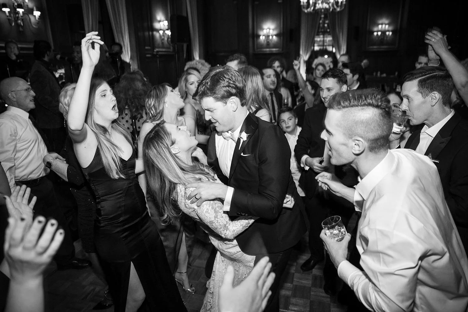 Bride and groom dancing surrounded by guests at the California Club during wedding reception