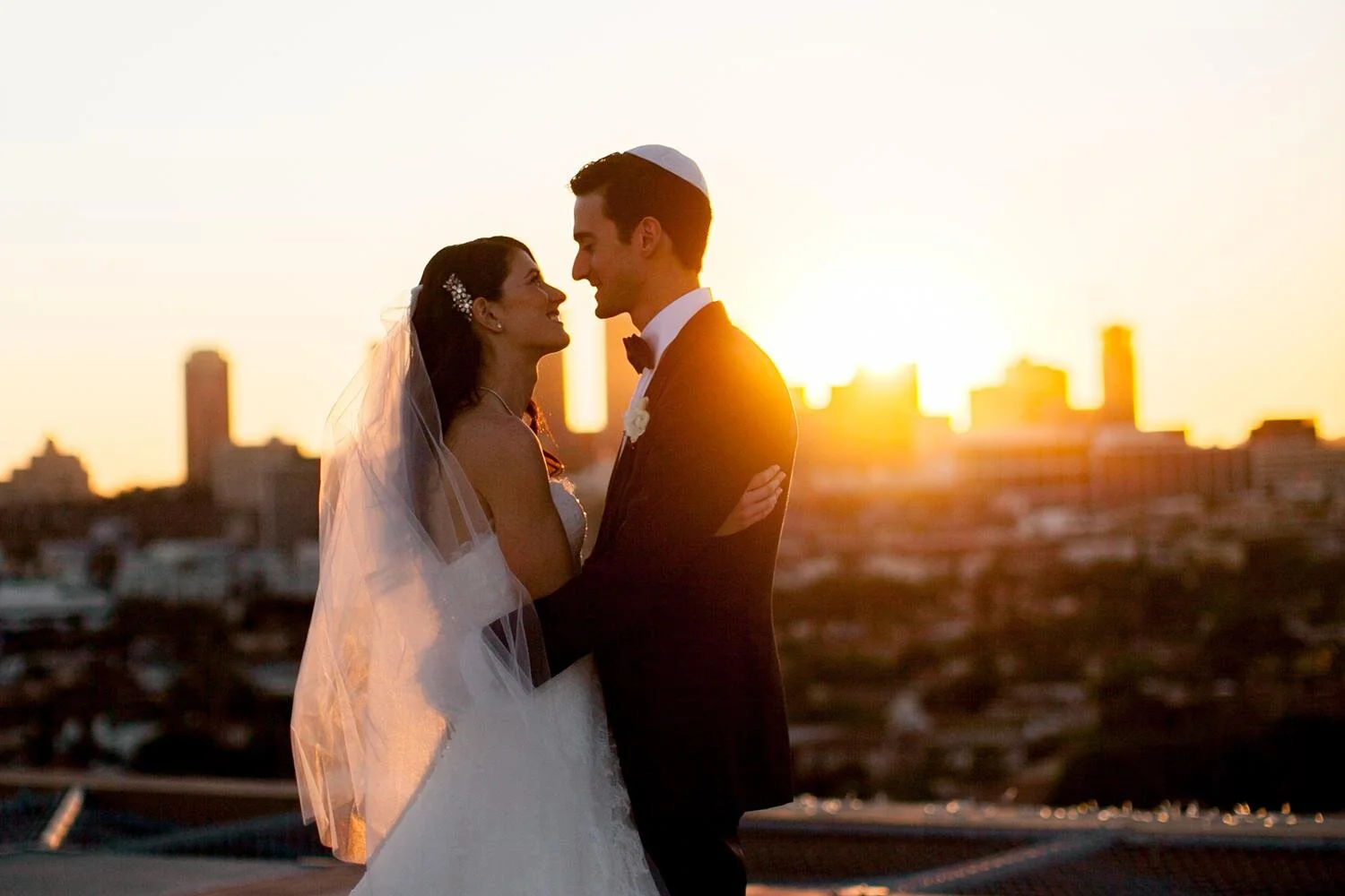 Golden hour wedding portraits of the bride and groom on a rooftop at the Four Seasons Los Angeles
