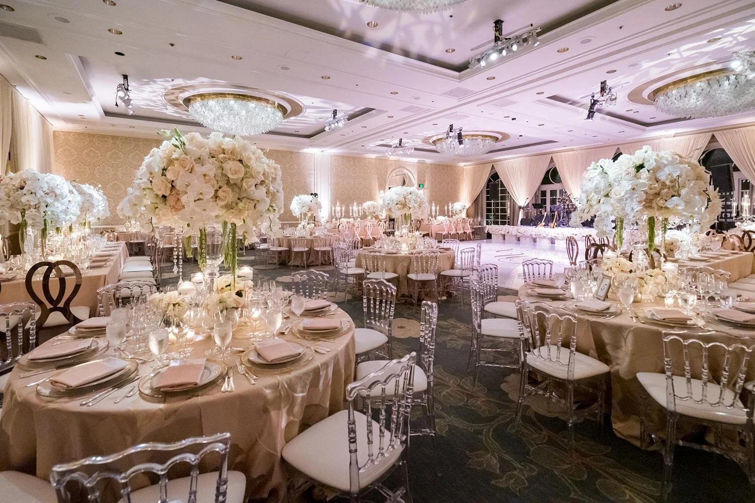 Pastel floral centerpieces displayed on reception tables during a ballroom wedding reception at the Four Seasons Los Angeles