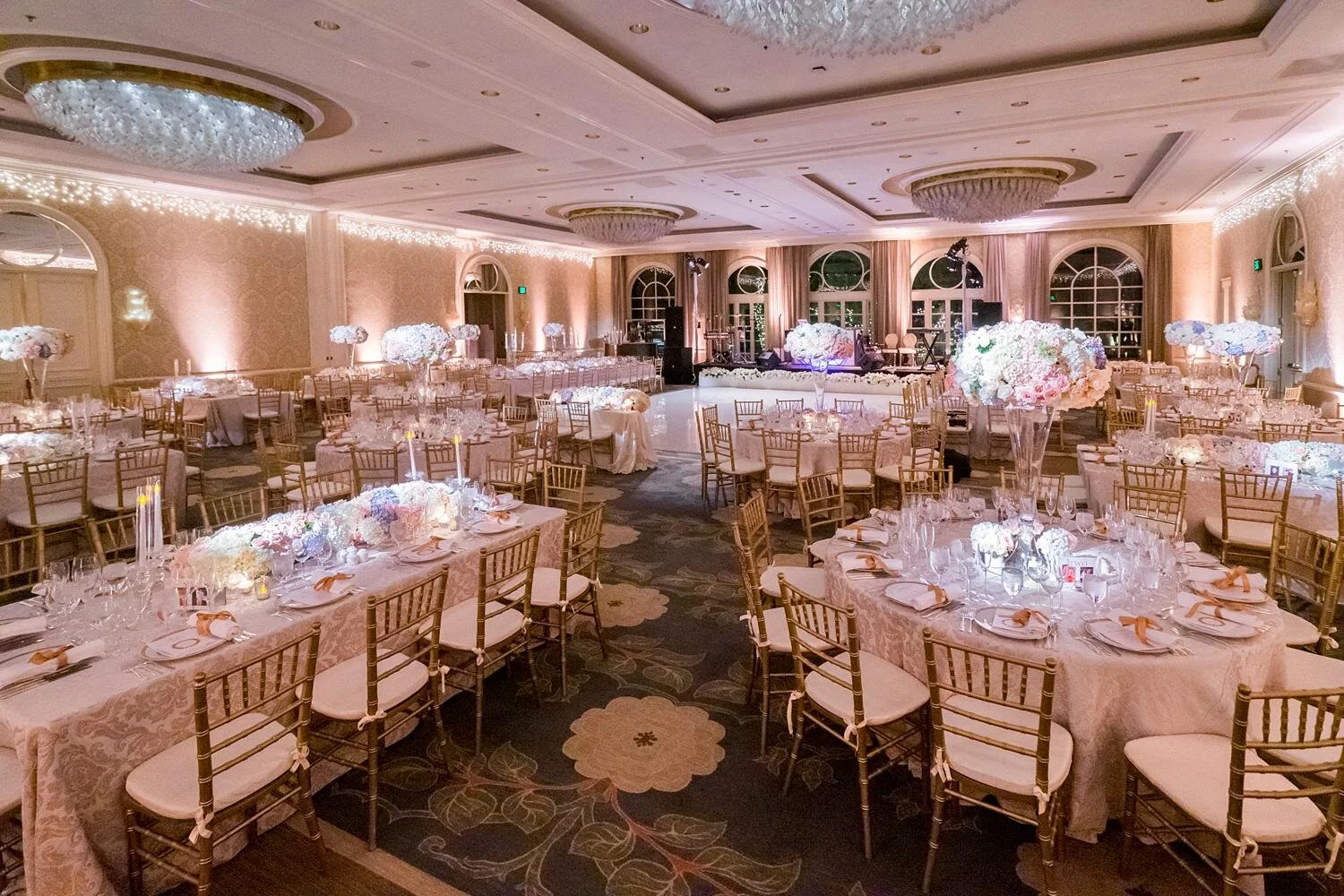 Candlelit tables and elegant décor at a ballroom wedding reception at the Four Seasons Los Angeles