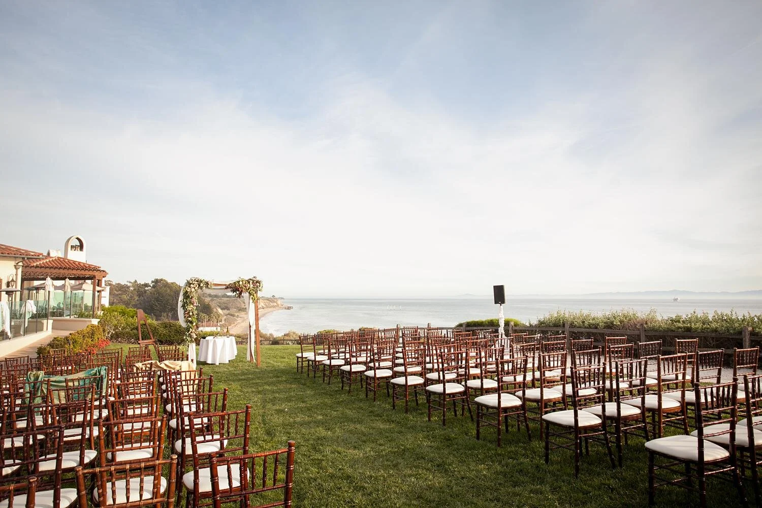 Wedding ceremony with chuppah and ocean backdrop on the Bluff Lawn at Ritz Carlton Bacara