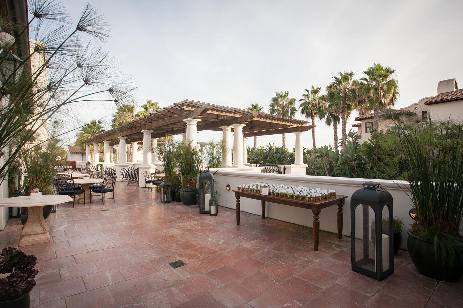 Wedding cocktails décor on the Terrace at Ritz Carlton Bacara featuring an escort card table