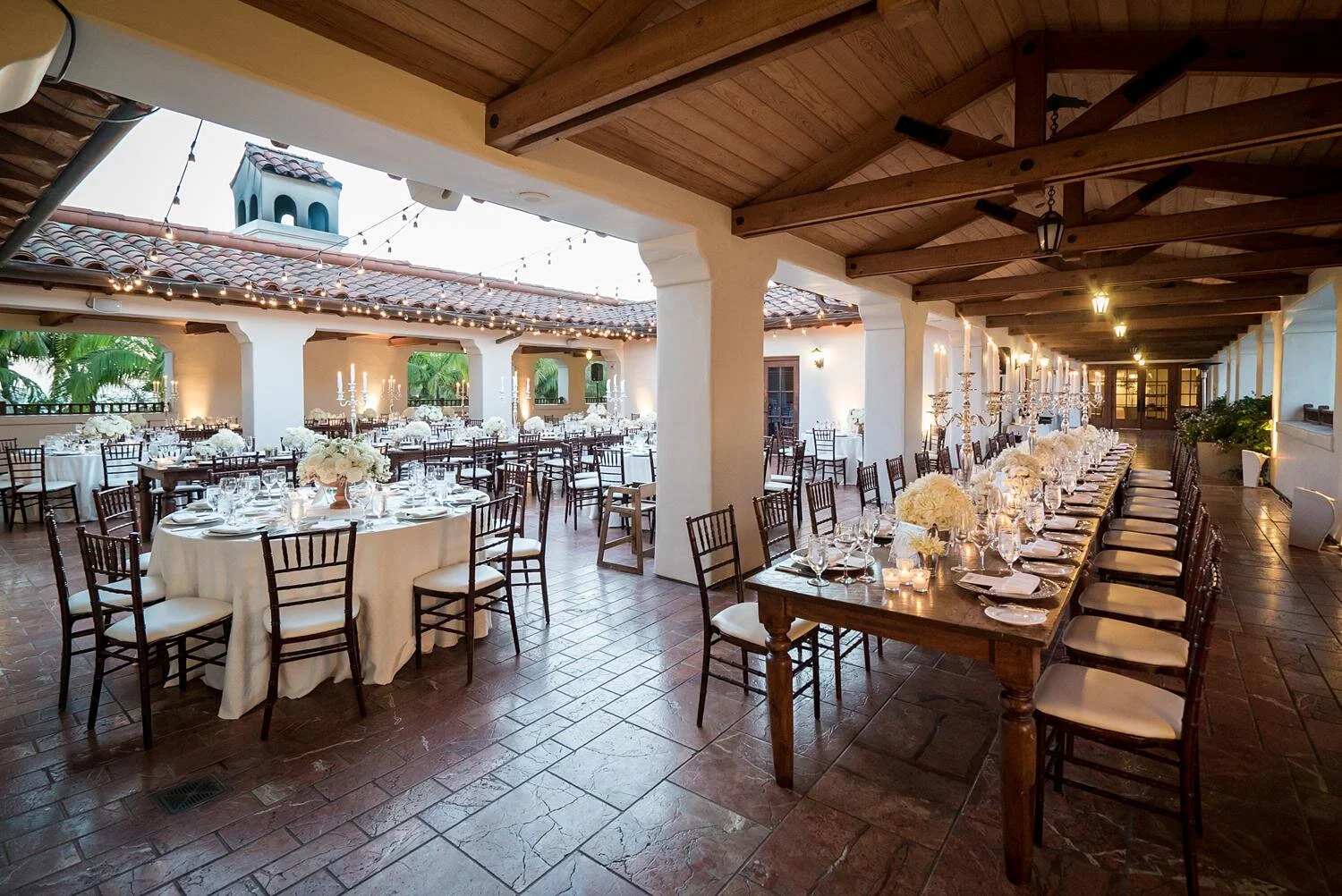 Wedding reception on the Rotunda Patio at Ritz Carlton Bacara with white florals and candelabras