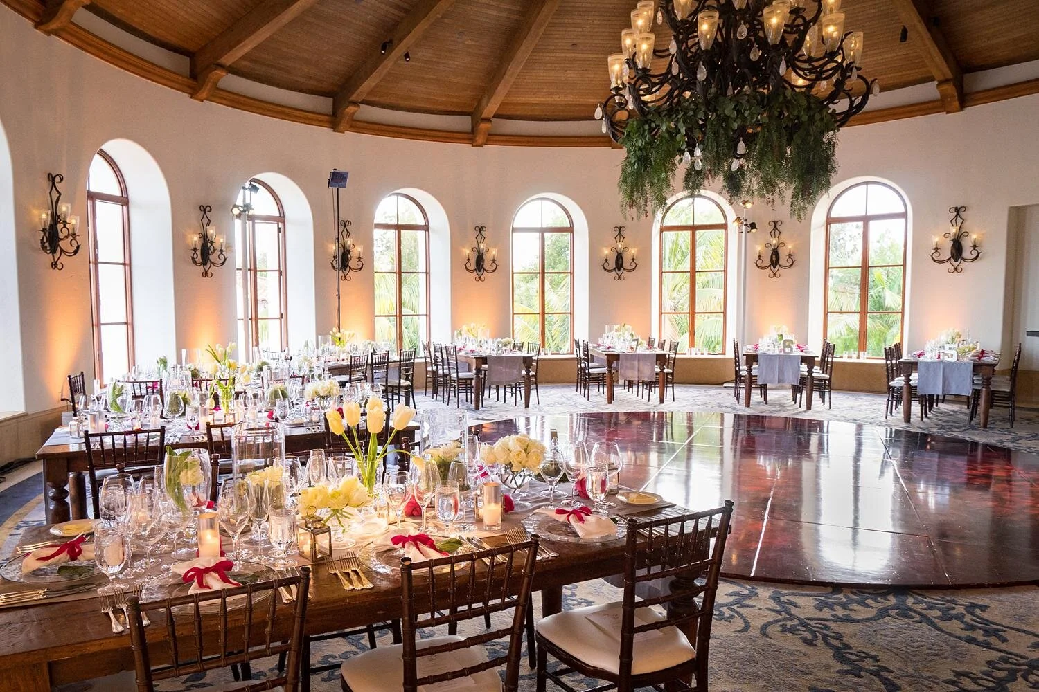 Wedding reception tables set for dinner inside the Rotunda at Ritz Carlton Bacara
