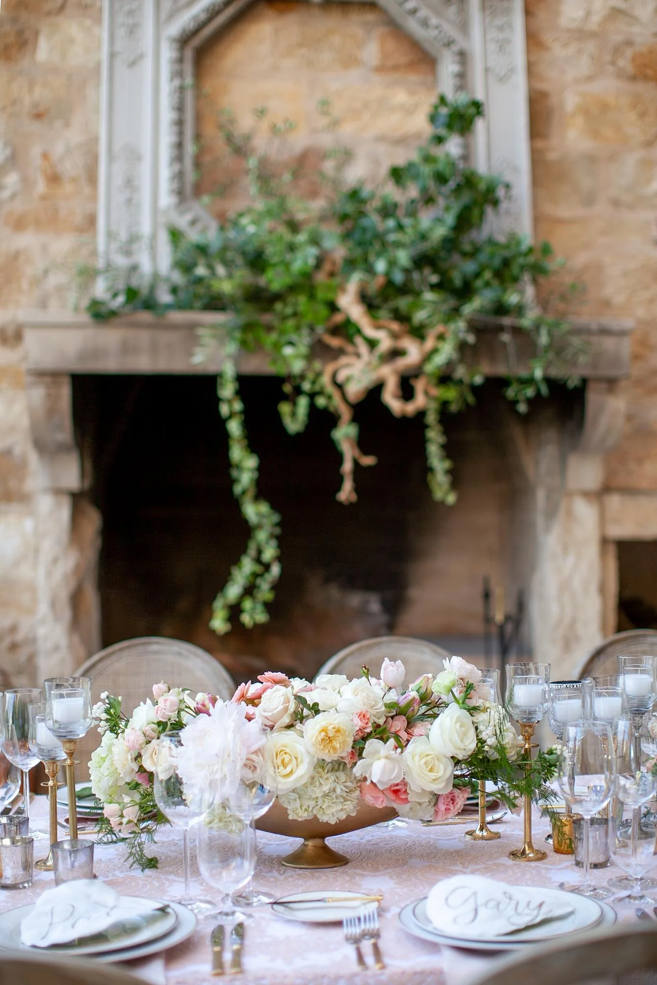 Wedding reception at Sunstone Winery and Villa with floral centerpiece detail near the fireplace