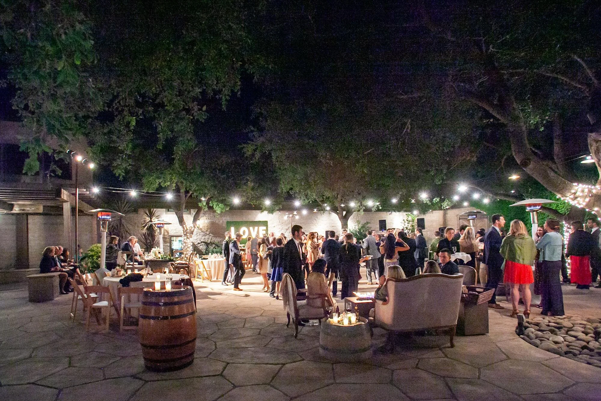 Wedding reception at Firestone Winery with guests dancing and mingling under string lights