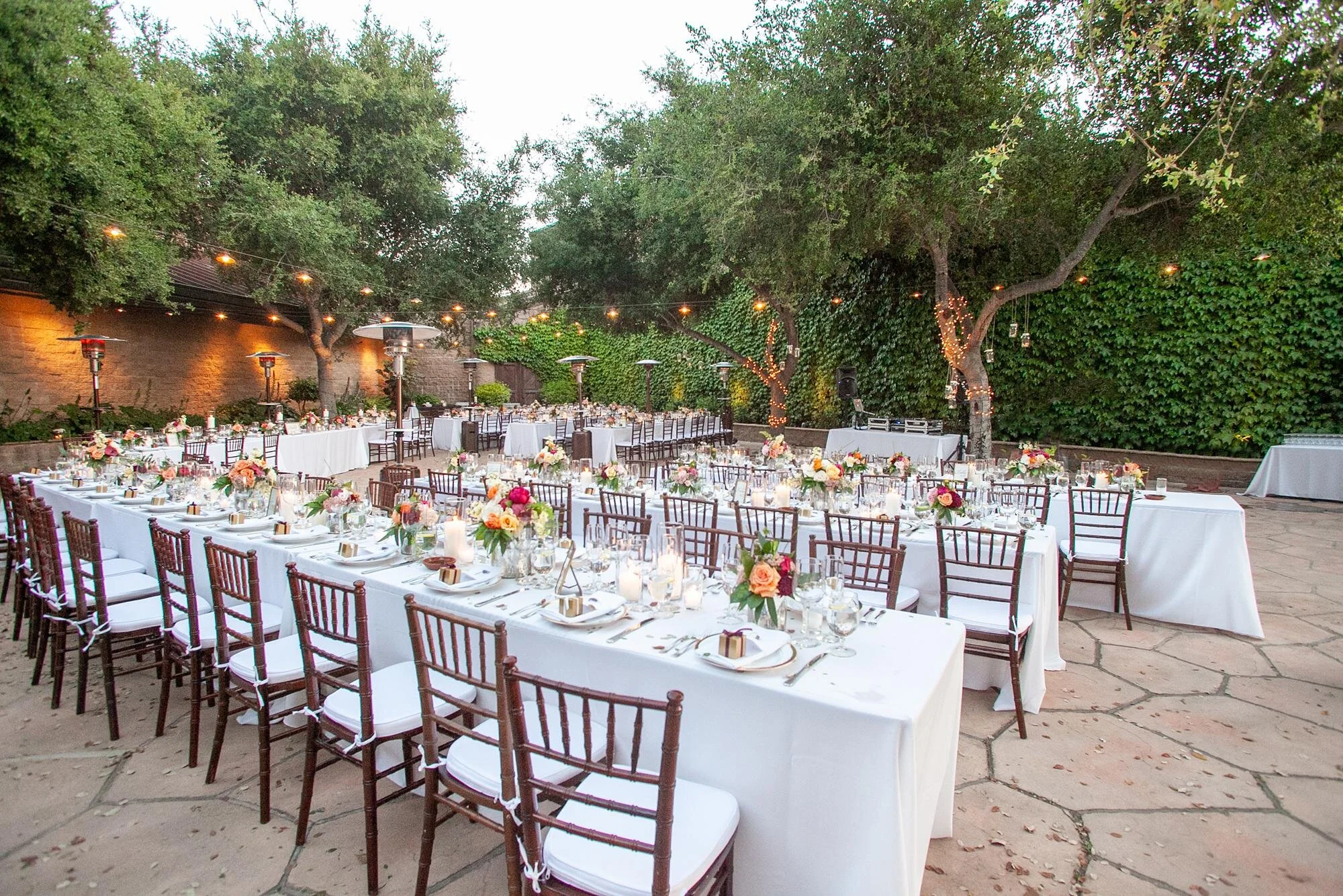 Wedding reception at Firestone Winery Courtyard with colorful florals and white linen tables