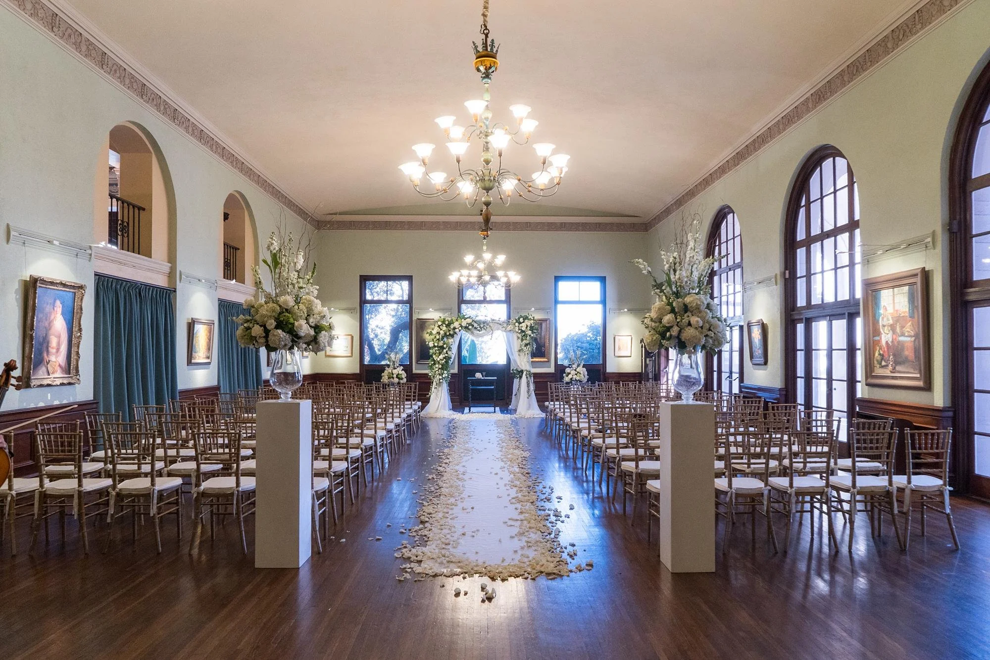 Jewish wedding ceremony under chuppah with white florals and drapery in Art Salon at Ebell of Los Angeles