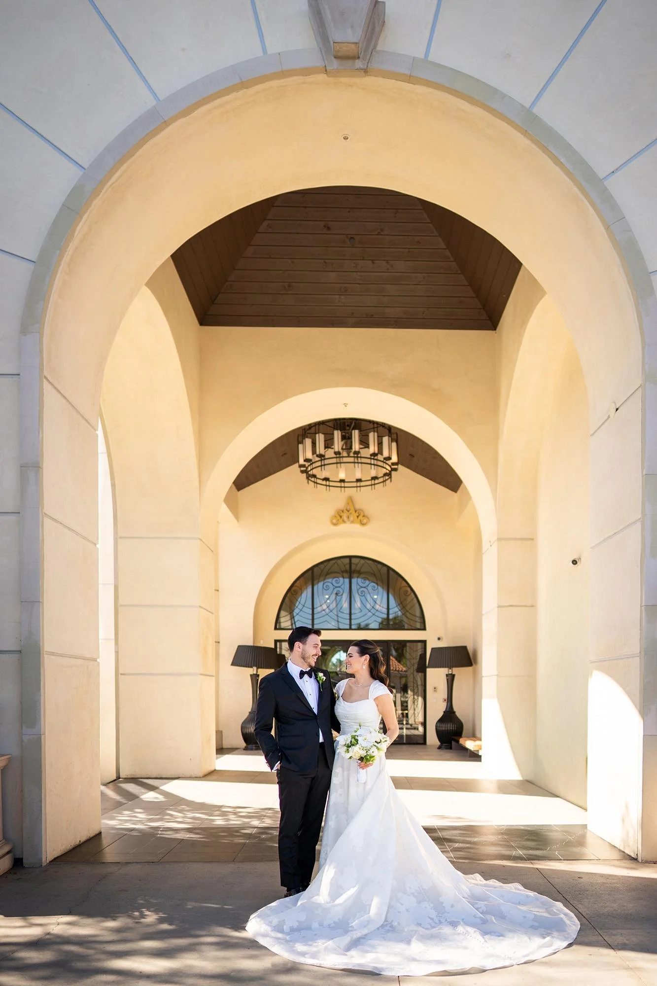 Wedding portraits at Landmark Mission Hills with bride and groom standing in arch
