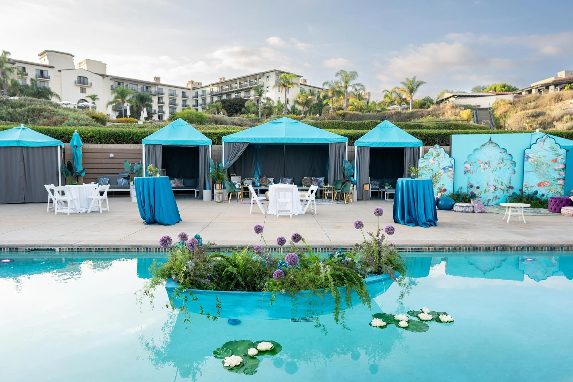 Wide view of Cielo Pool Sangeet with teal and purple accents and resort background at Terranea Resort