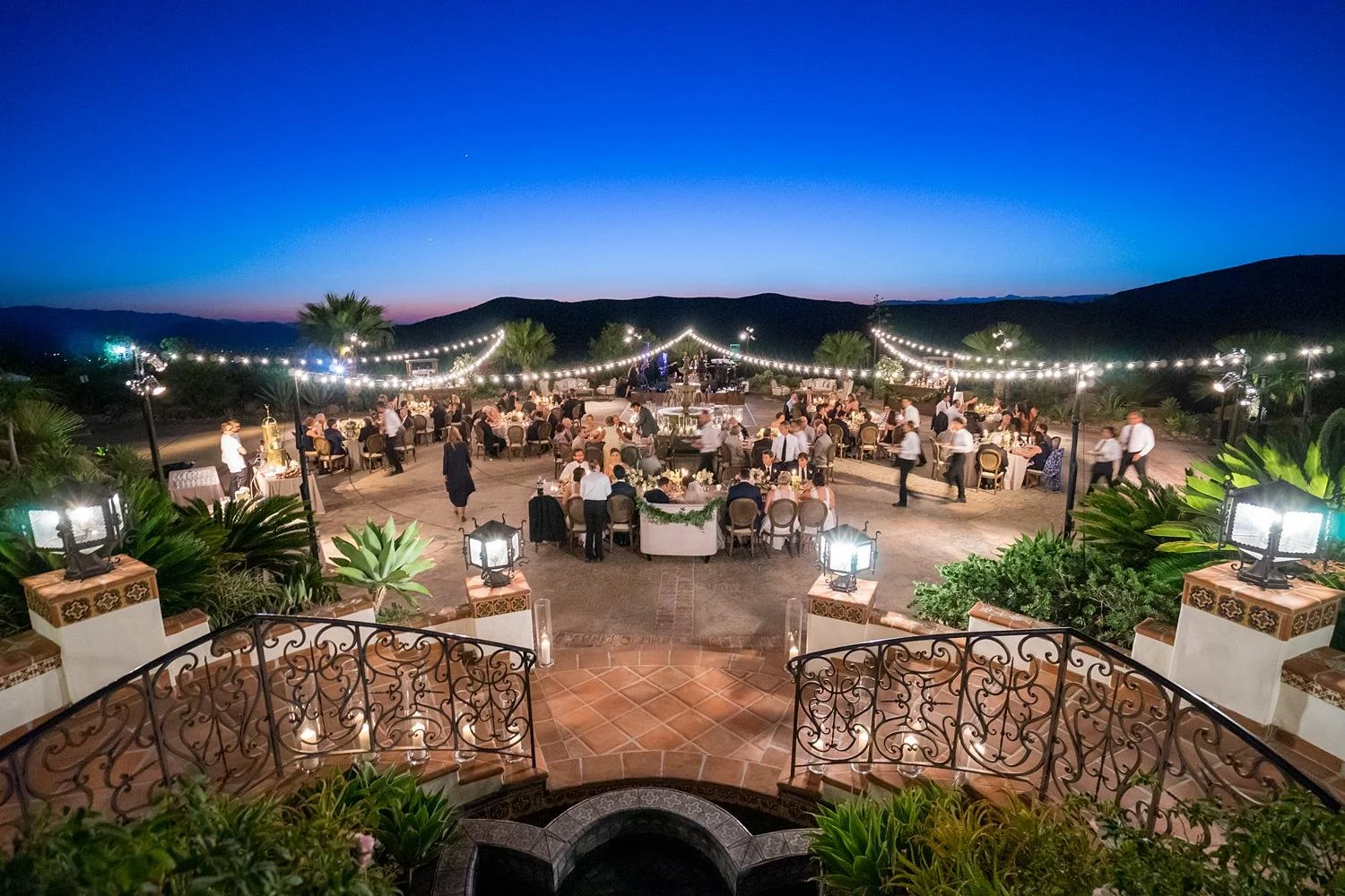 Guests enjoying dinner at sunset during a Villa wedding reception at Hummingbird Nest Ranch