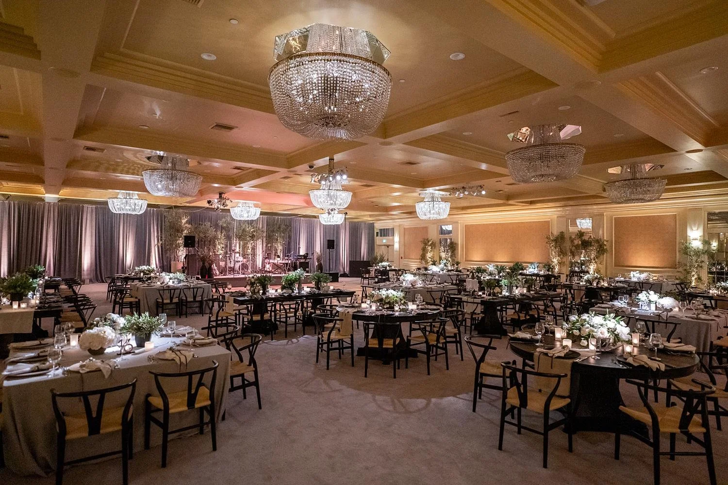Wide view of Wedgwood Ballroom wedding reception with tables, band stage, and lighting at Fairmont Miramar