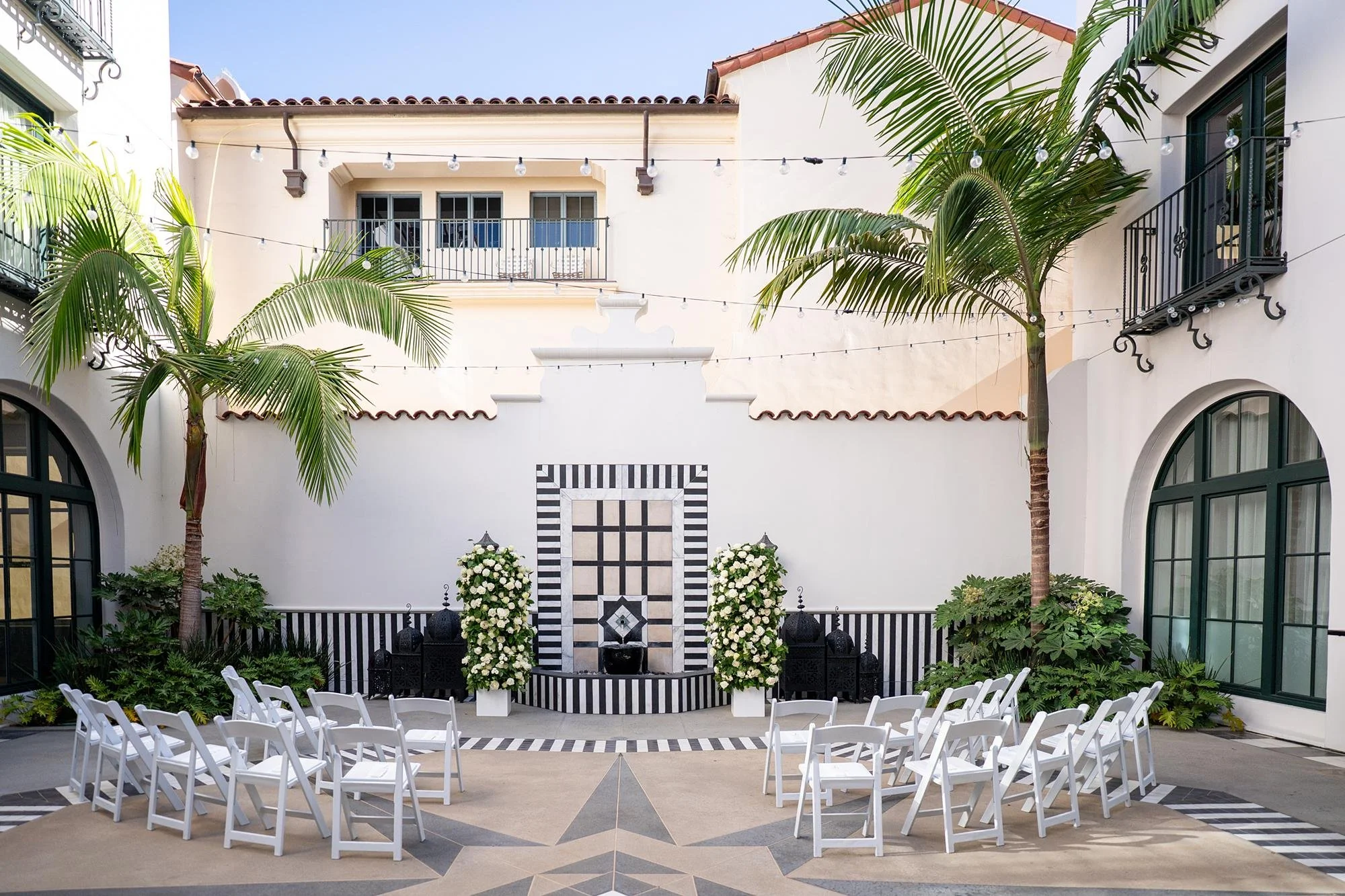 Wedding ceremony at Hotel Californian Court of Fatima with florals beside fountain