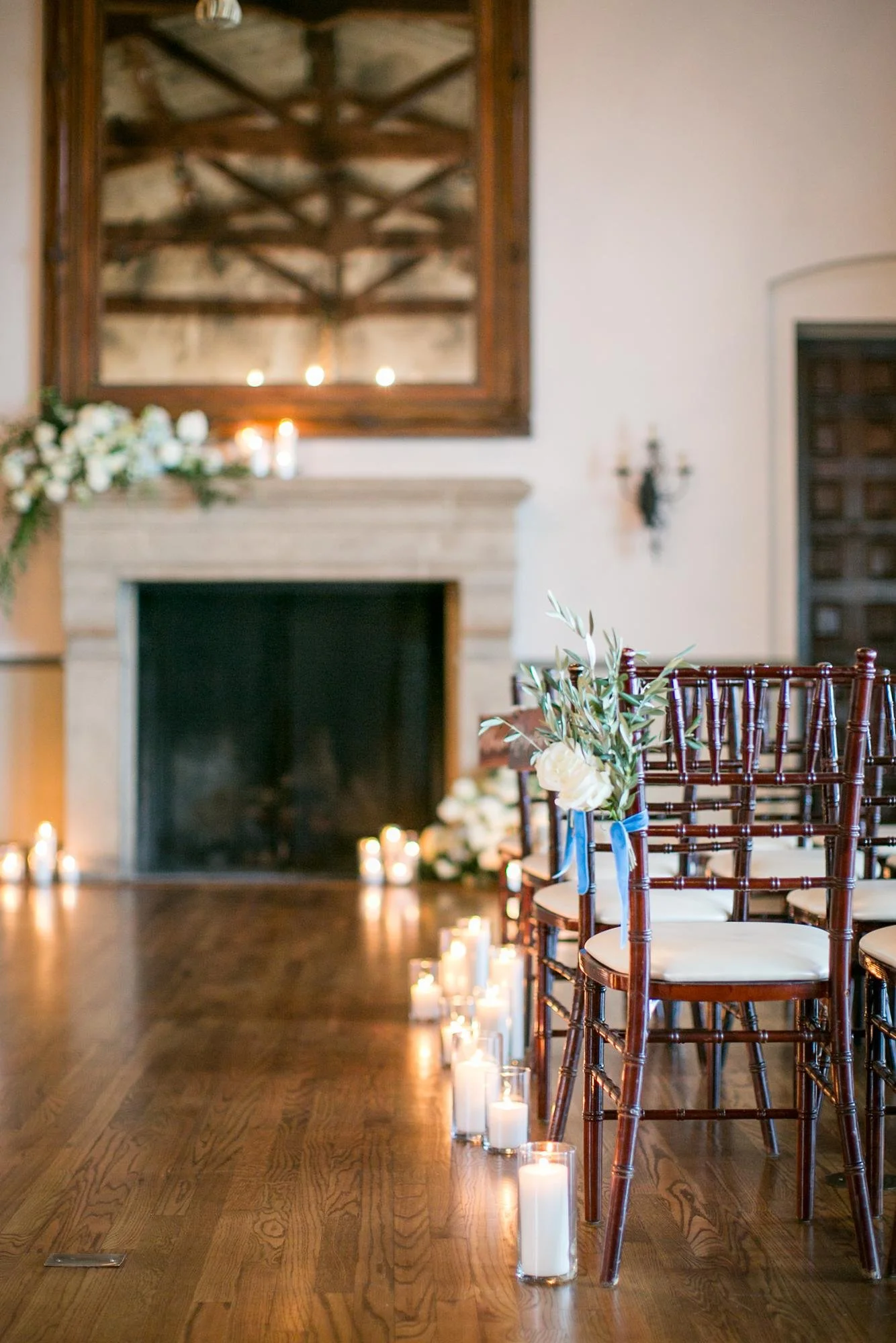 Wide view of living room wedding reception setup with tables and decor at the Bel Air Bay Club