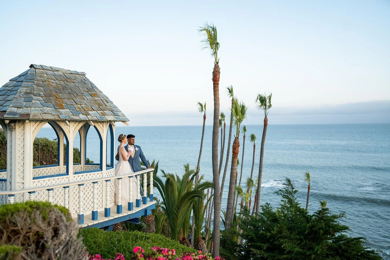 Wedding portraits of bride and groom overlooking the ocean from a gazebo at Cypress Sea Cove