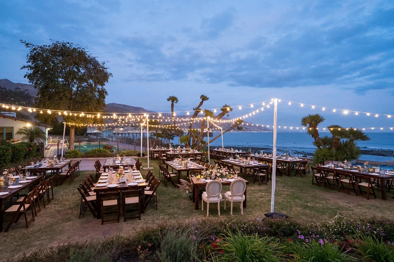 Wedding reception at Adamson House under string lights on the Back Lawn