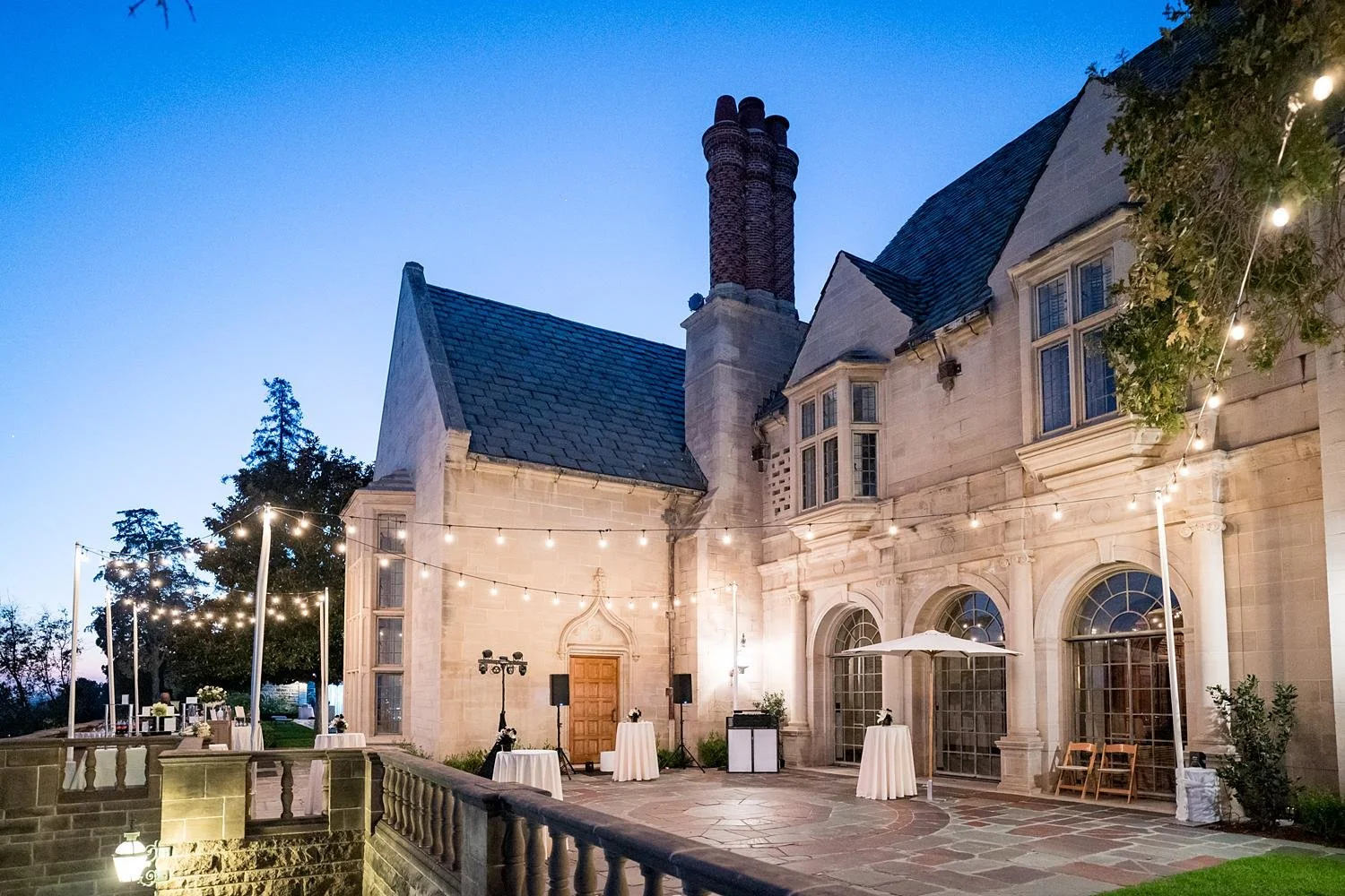 Wedding reception on the Mansion Terrace at Greystone Mansion with dance floor and string lights