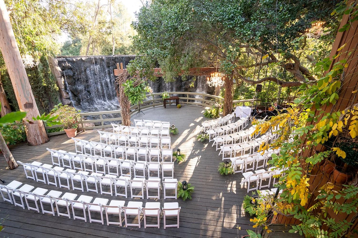 Wedding ceremony at Calamigos Ranch at the Oak Room with ferns and lanterns lining the aisle