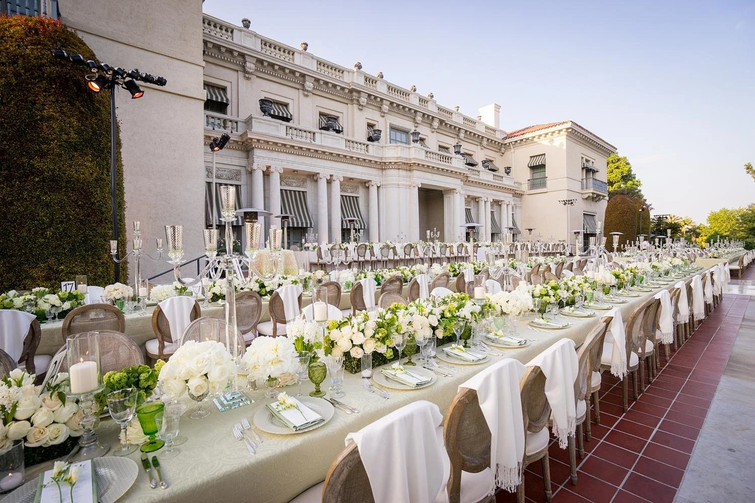 Wedding reception on South Terrace with long tables, florals and candles at Huntington Library